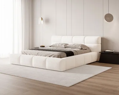A modern bedroom with a white upholstered bed.