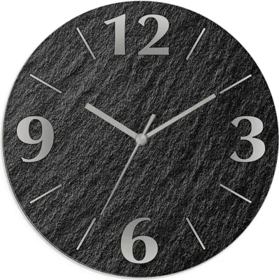 A close-up view of a round wall clock with a slate-like texture and silver hour markers and hands.