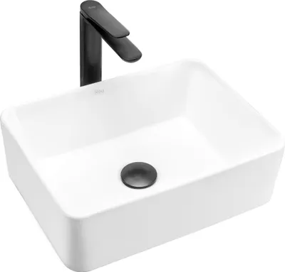 A white rectangular sink with a black faucet and drain.