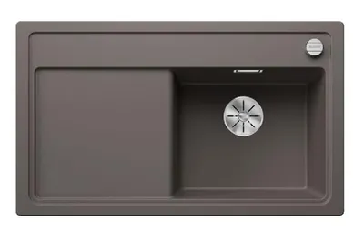 A top-down view of a gray kitchen sink with a silver drain.