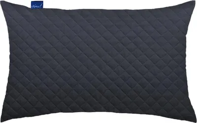A dark gray quilted pillow on a white background.