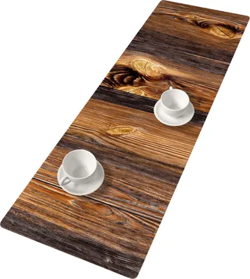 A table runner with a wood grain pattern, featuring two coffee cups and saucers.