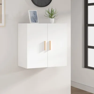 A white wall-mounted cabinet with two wooden handles is shown against a white wall. A framed picture and a potted plant are on top of the cabinet.