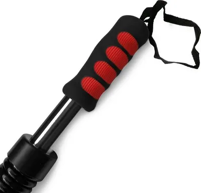 Close-up of a black and red grip on a metal rod, with a black strap attached.