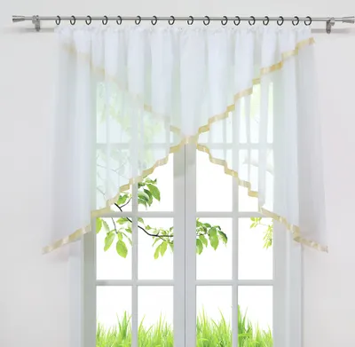 A white sheer curtain with gold trim is hung on a window.