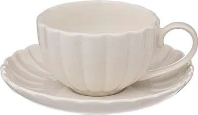 A white porcelain teacup and saucer with a fluted design.