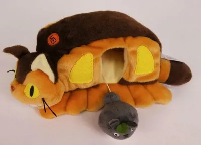 A plush toy of the Catbus from My Neighbor Totoro, with a small mouse toy attached by a string.