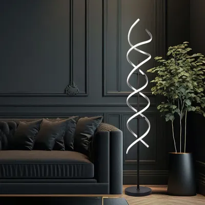 A modern living room with a dark gray tufted sofa and a tall, spiral floor lamp.