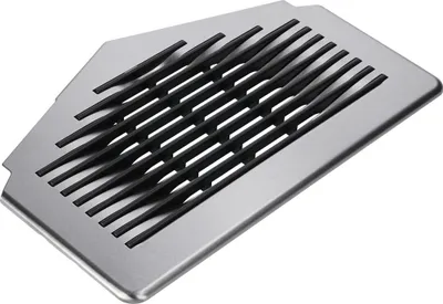 A close-up studio shot of a coffee machine drip tray.