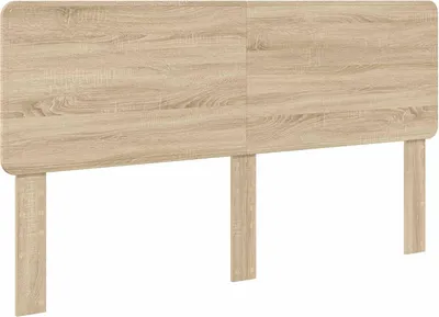 A product shot of a wooden headboard with two legs.