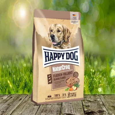 A bag of dog food is shown in an outdoor setting with grass and bokeh lights.