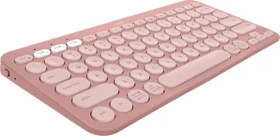 A pink Logitech Pebble Keyboard 2 K380s is shown from a diagonal angle against a white background.