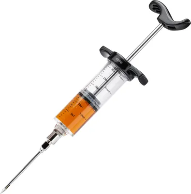 A close-up shot of a BBQ marinade injector filled with orange liquid, set against a white background.