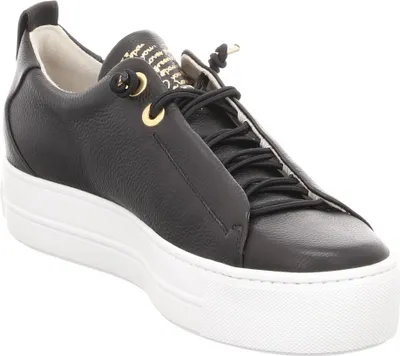 A black leather sneaker with a white platform sole is shown against a white background.