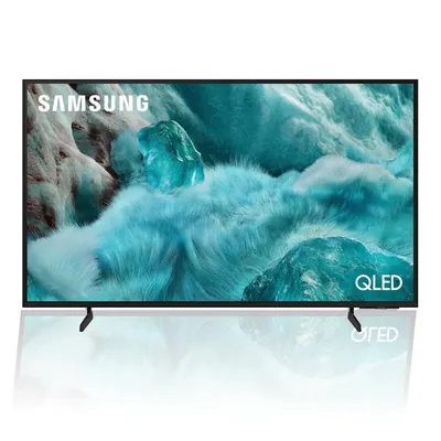 A Samsung QLED TV is displayed on a white background with its reflection.