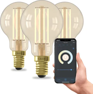 A hand holding a smartphone displaying a smart lighting app, with three smart LED bulbs in the background.