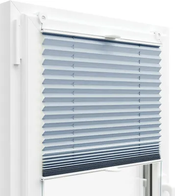 A close-up view of a light blue pleated blind installed in a white window frame.
