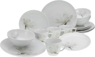 A collection of white porcelain dinnerware with a floral design.
