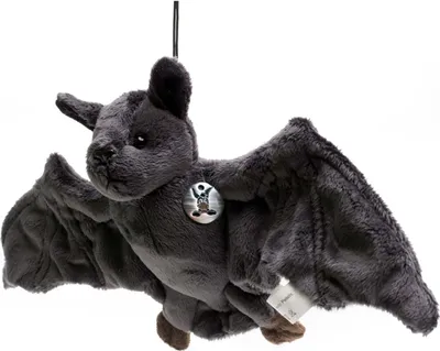A plush toy bat hanging against a white background.
