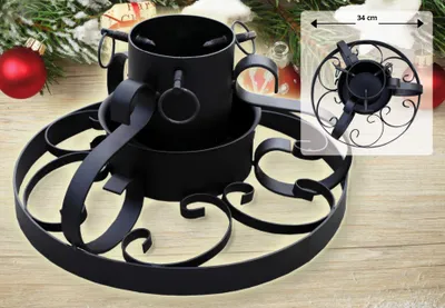A black metal Christmas tree stand is displayed on a wooden surface, with festive decorations like a red ornament and greenery in the background. An inset shows a close-up of the stand's base with a size indicator.