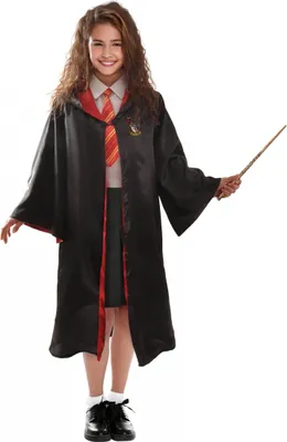 A young girl dressed as a wizard, holding a wand.