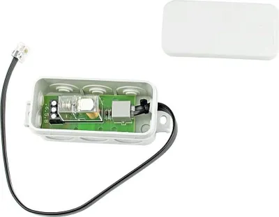 A white electronic device with a green circuit board inside, connected to a black wire with a connector.