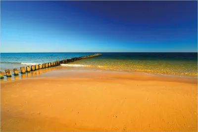 Produktbild von Wallario Poster - Sandstrand in orange - Blaues Meer - Blauer Himmel, Kunstdruck Größe: 100 x 150 cm