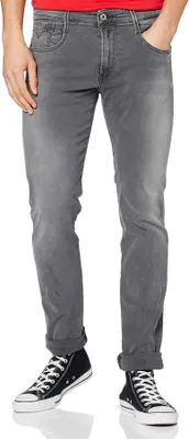 A person wearing Replay jeans and black Converse sneakers.