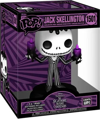 A Funko Pop! Deluxe figure of Jack Skellington from The Nightmare Before Christmas, displayed in its original packaging. The packaging features a purple and black geometric pattern and the Funko Pop! branding. The figure itself is holding two purple candle