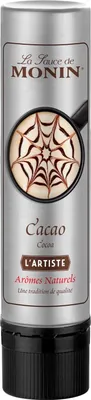 A bottle of Monin Cacao sauce with a decorative latte art design on the label.