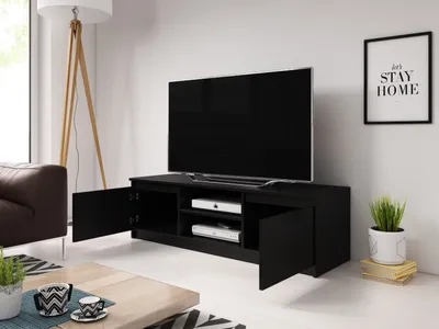 A black TV stand with a large TV on top in a living room setting.