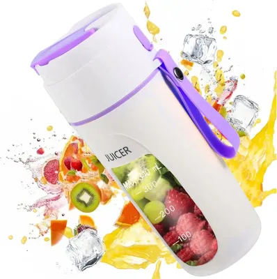 A portable juicer surrounded by splashes of juice, fruit slices, and ice cubes.