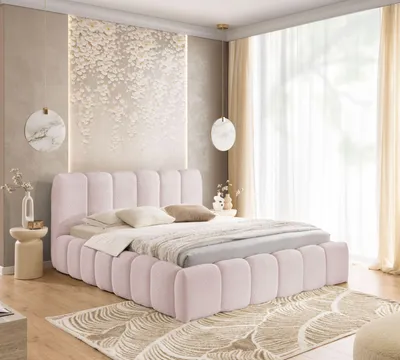 A bedroom scene featuring a pink upholstered bed.