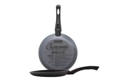Two frying pans are shown, one stacked on top of the other, against a white background. The top pan is shown from the underside, revealing text and logos. The bottom pan is shown from the side.