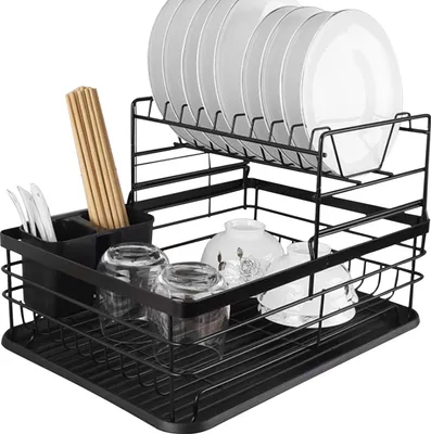 A two-tier black metal dish rack filled with dishes, bowls, glasses, and chopsticks.