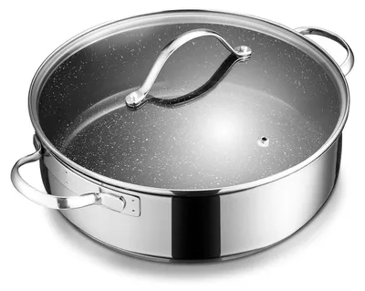 A close-up studio shot of a stainless steel pot with a speckled interior and a glass lid.