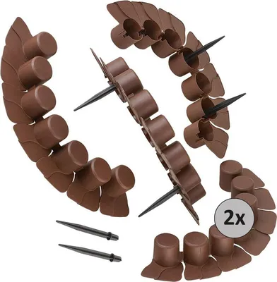 Several brown garden border pieces arranged in curves, with black stakes.
