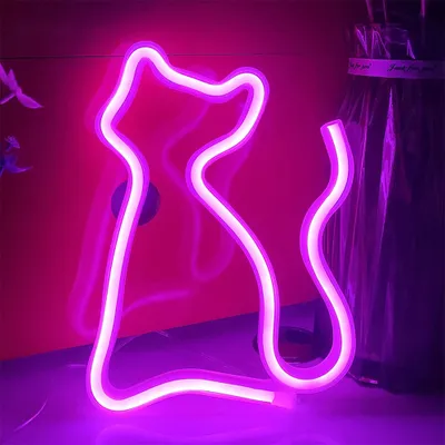 A neon cat sign is displayed against a pink wall.