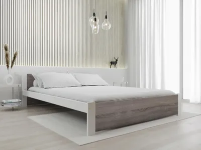 A modern bedroom with a bed, bedside table, and decorative elements.
