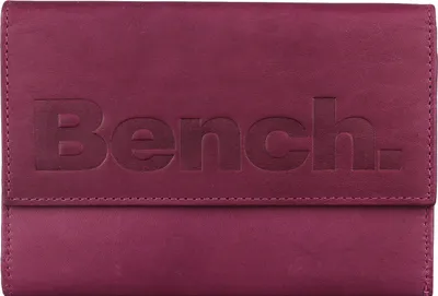 A close-up, front-facing view of a closed berry-colored leather wallet with the embossed 'Bench.' logo.