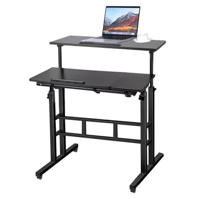 A black adjustable height computer desk with a laptop and a cup on it, shown against a white background.