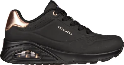 A side view of a black Skechers sneaker with rose gold accents.