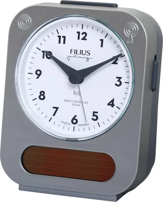 A close-up studio shot of a gray alarm clock with a white face.