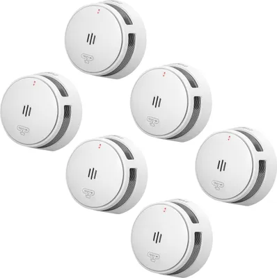 A group of white smoke detectors arranged in a cluster against a white background.