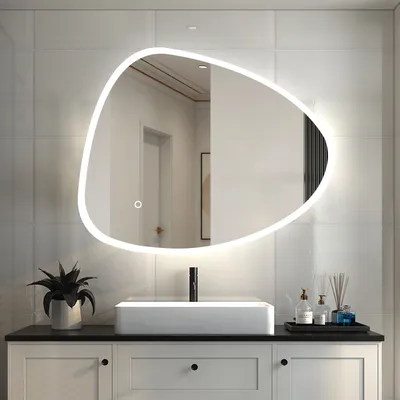 A modern bathroom vanity with a rectangular sink and a large, irregularly shaped illuminated mirror above it.