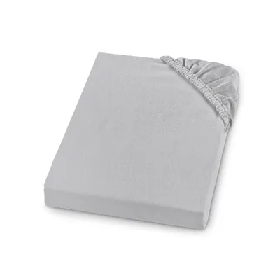A light gray fitted sheet is shown lying flat on a white background, with the elasticized corner visible.
