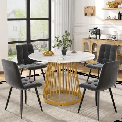 A dining set with a round table and four chairs in a dining room.