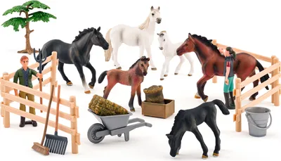 A collection of toy horses, a farmer figure, a tree, and farm accessories arranged on a white background.