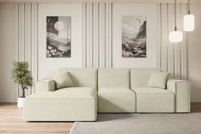 A modern living room with a beige sectional sofa, two abstract paintings on the wall, and pendant lights.