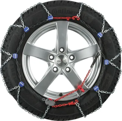 A snow chain is mounted on a car tire and wheel.